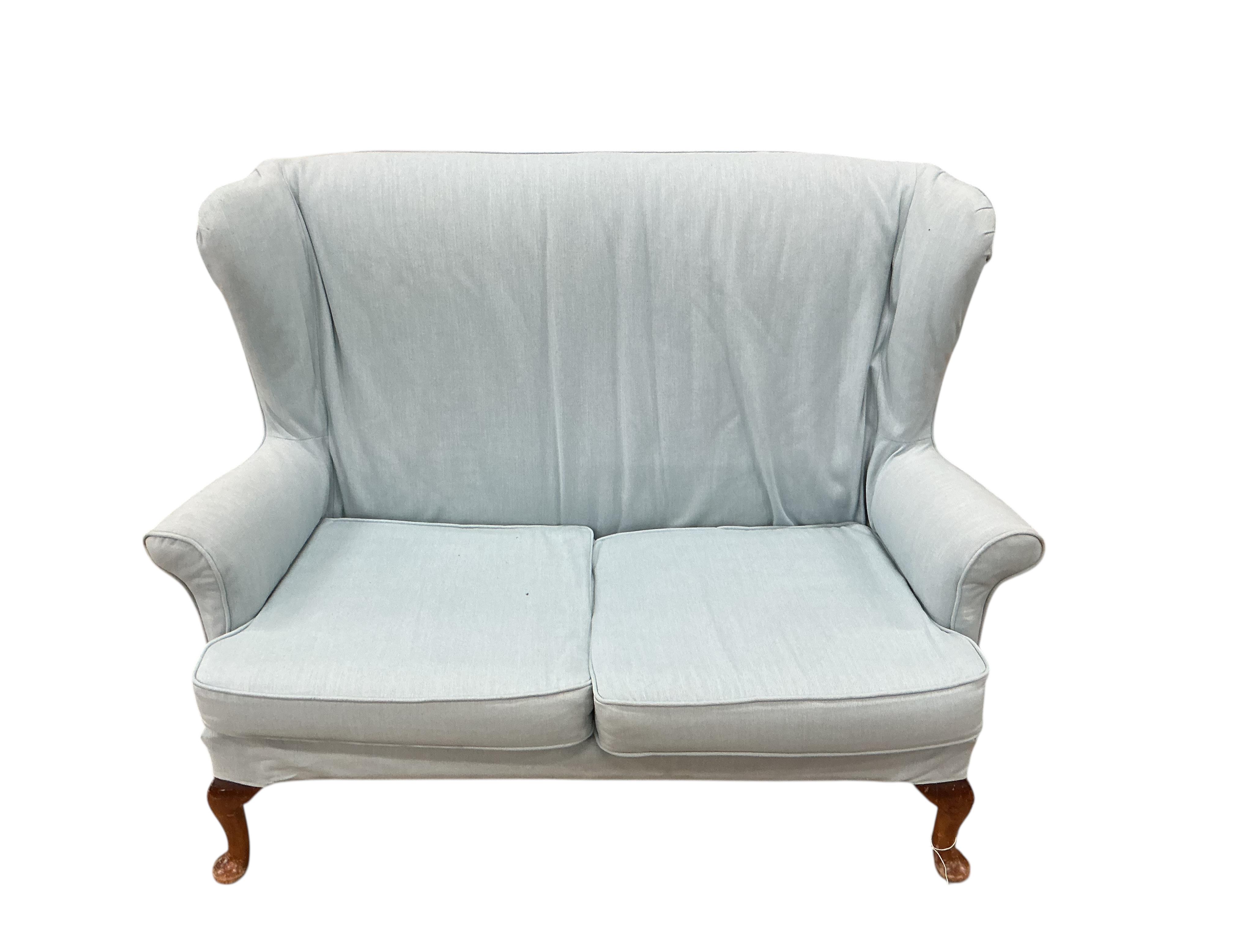 A Parker Knoll wing back upholstered two seater settee, width 136cm, depth 70cm, height 96cm